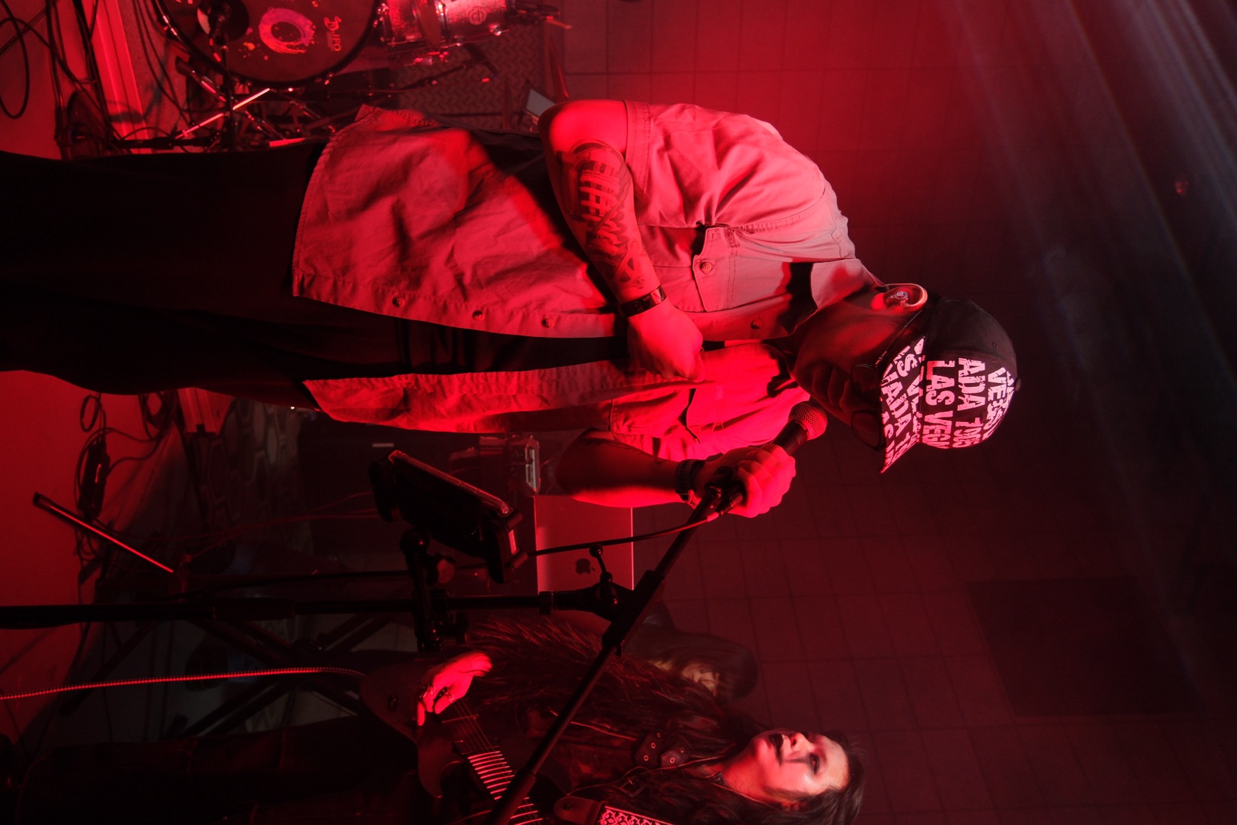 Edward performing with his band in red stage lighting
